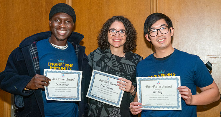 three people holding awards